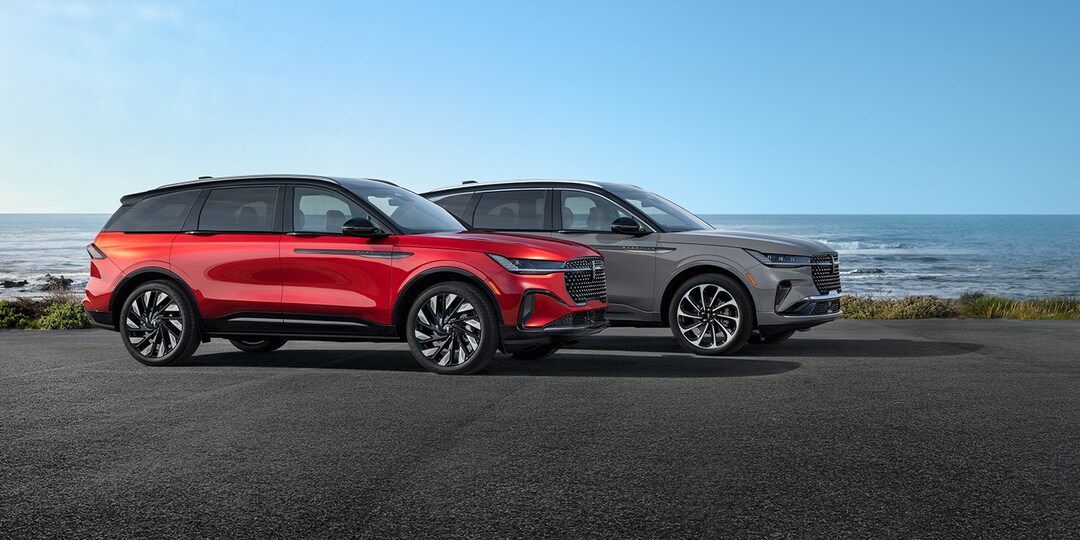 Profile shot of two Lincoln SUVs parked on road