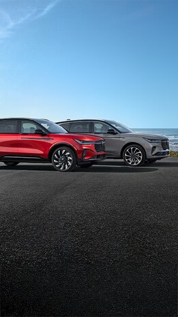 Profile shot of two Lincoln SUVs parked on road