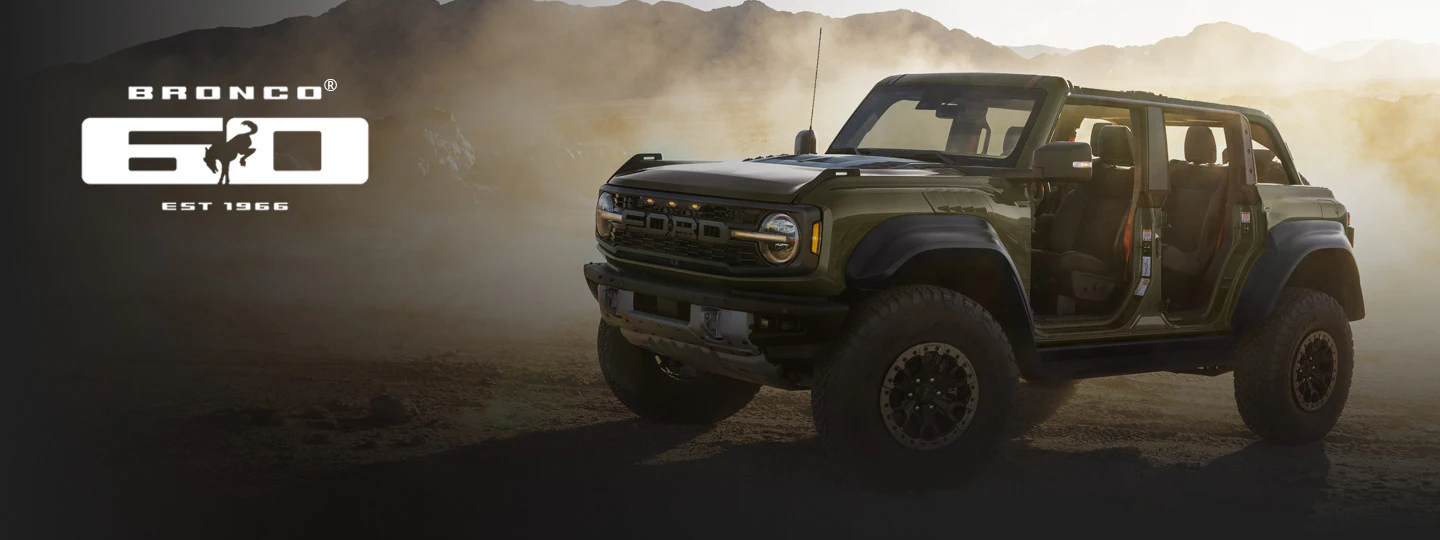 Ford Bronco® SUV with doors removed, in a dusty, mountainous landscape