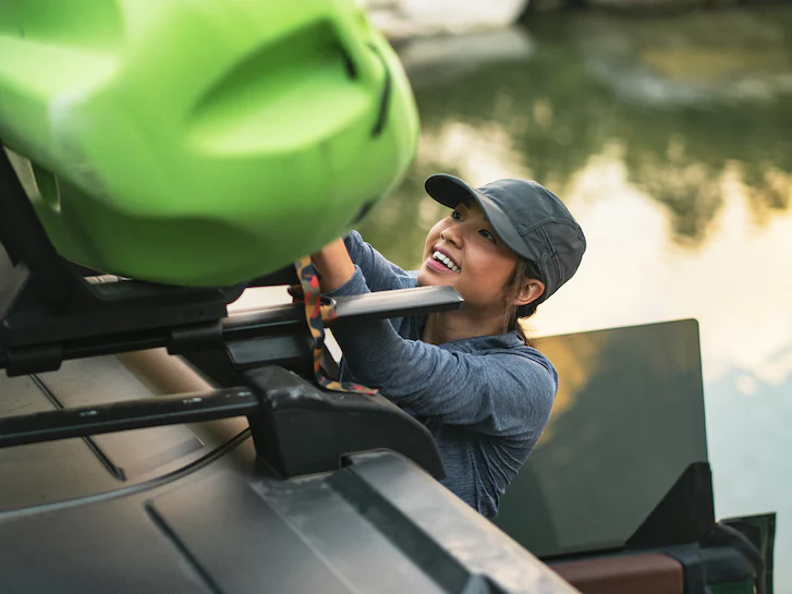 Closeup of a person loading a kayak onto a 2025 Ford Bronco® rooftop carrier