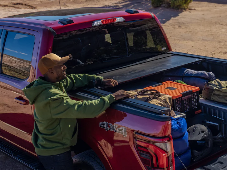 A 2025 Ford Truck pictured F-150® as a man closes up a tonneau cover