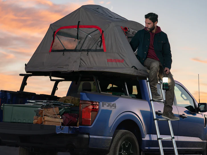 A 2025 Ford Truck F-150® as a man enters a bed-mounted tent