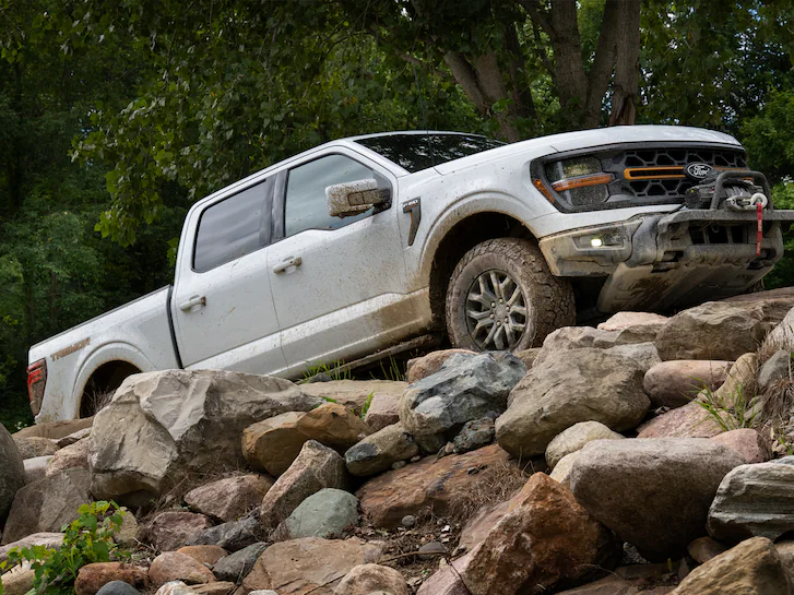 A 2025 Ford Truck F-150® being driven up a rocky road