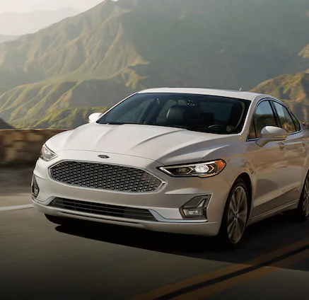 A 2025 Ford Fusion® being driven on a cirvy mountain road