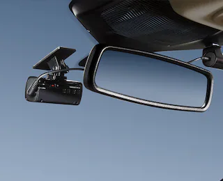 Closeup of a dash cam mounted to windshield