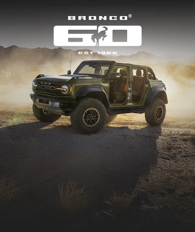 Ford Bronco® SUV with doors removed, in a dusty, mountainous landscape