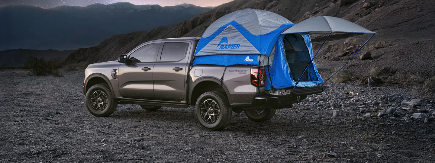 Three people riding bicycles near a parked 2026 Ford Expedition® Tremor® SUV