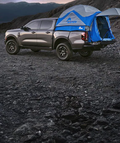 Three people riding bicycles near a parked 2026 Ford Expedition® Tremor® SUV