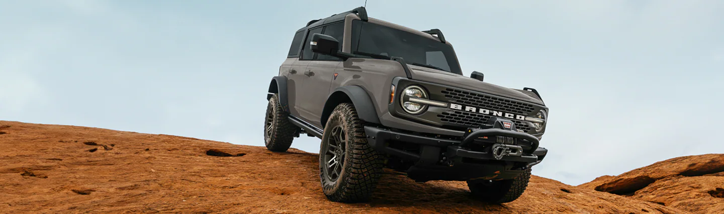 A 2026 Ford Bronco® SUV being driven down a dirt hillside