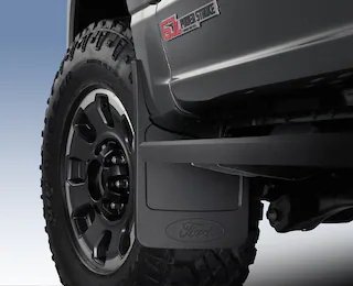 Closeup of a Ford Super Duty® front wheel splash guard and wheel molding