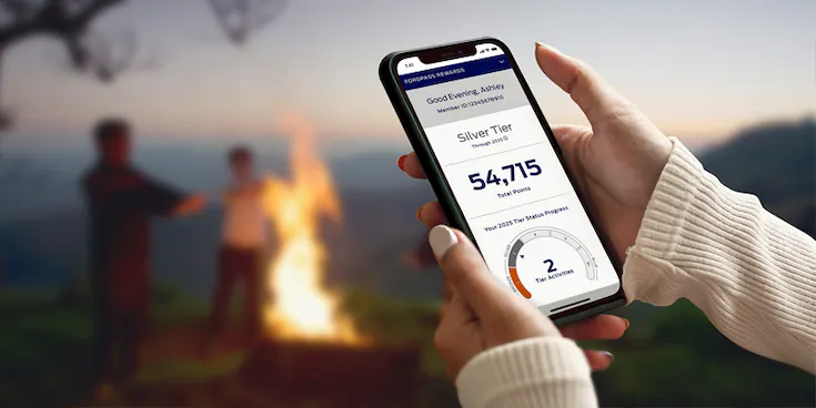 Closeup of a smartphone with FordPass™ Dashbaord