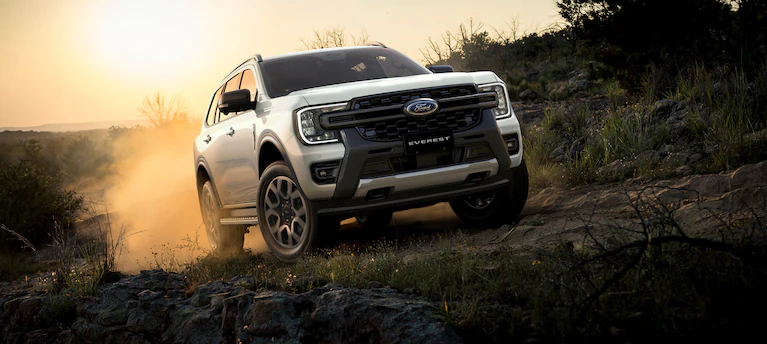 A couple loading a kayak onto a 2024 Bronco® SUV with a kayak rack