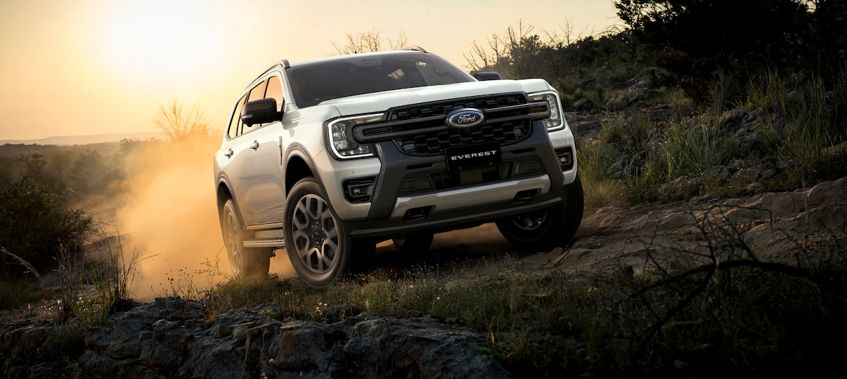 A couple loading a kayak onto a 2024 Bronco® SUV with a kayak rack